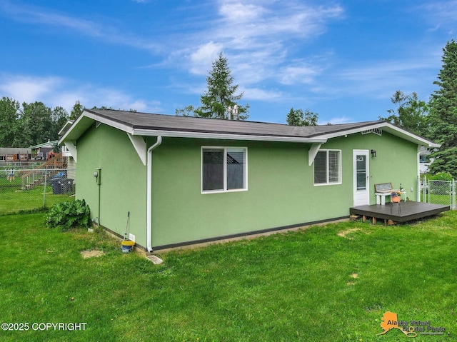 3306 E 19th Ct, Anchorage, AK 99508 - rear view of property featuring stucco siding and a deck