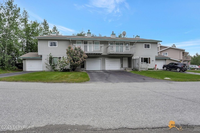 791 N Yakima St, Wasilla, AK 99654 - view of front of house with a balcony, driveway, a chimney, and a front lawn