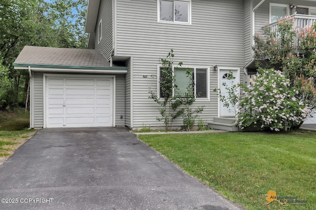 791 N Yakima St, Wasilla, AK 99654 - view of front of home featuring a garage, asphalt driveway, and a front lawn