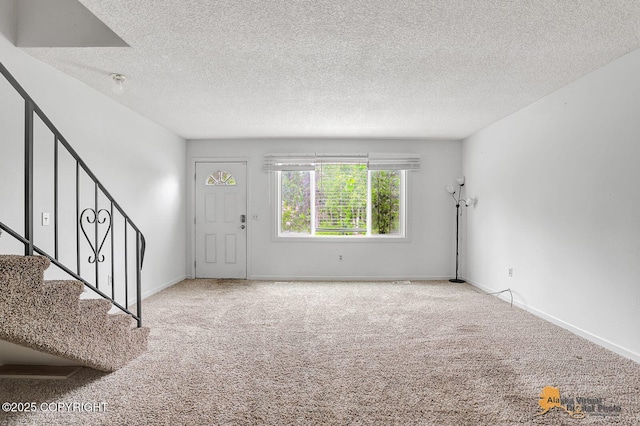791 N Yakima St, Wasilla, AK 99654 - foyer featuring carpet flooring, a textured ceiling, and stairway