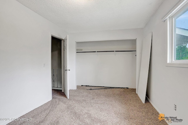791 N Yakima St, Wasilla, AK 99654 - unfurnished bedroom with carpet flooring, a closet, and a textured ceiling