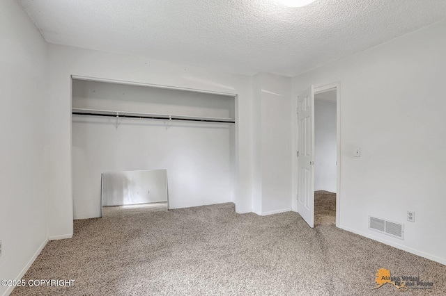 791 N Yakima St, Wasilla, AK 99654 - unfurnished bedroom featuring carpet floors, a closet, and a textured ceiling