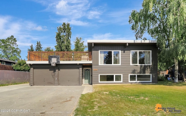 1915 Stanford Dr, Anchorage, AK 99508 - view of front of home featuring driveway, a front lawn, a balcony, and a garage