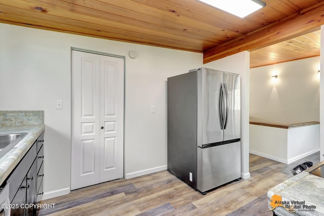 1915 Stanford Dr, Anchorage, AK 99508 - kitchen with freestanding refrigerator, wooden ceiling, light wood-style floors, and light countertops