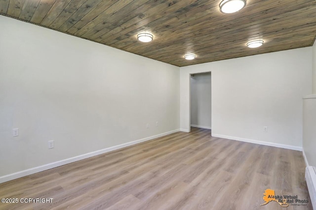 1915 Stanford Dr, Anchorage, AK 99508 - empty room featuring wood finished floors, a baseboard heating unit, and wooden ceiling