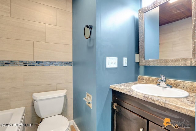 1915 Stanford Dr, Anchorage, AK 99508 - bathroom featuring vanity, a tub to relax in, and tile walls