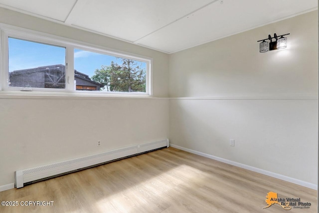 1915 Stanford Dr, Anchorage, AK 99508 - unfurnished room featuring baseboard heating and light wood-type flooring