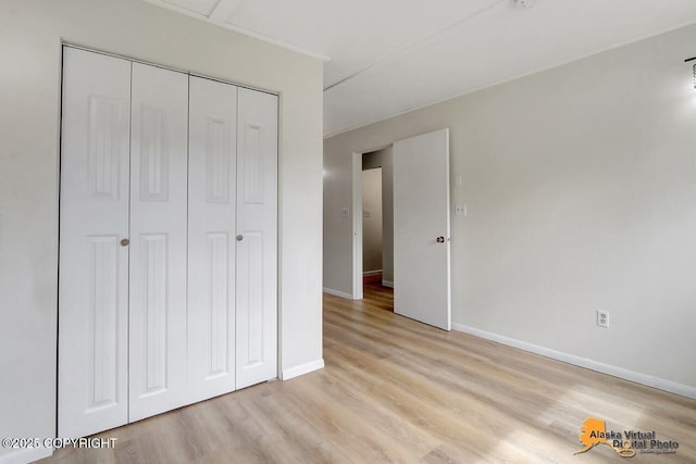 1915 Stanford Dr, Anchorage, AK 99508 - unfurnished bedroom with light wood finished floors and a closet