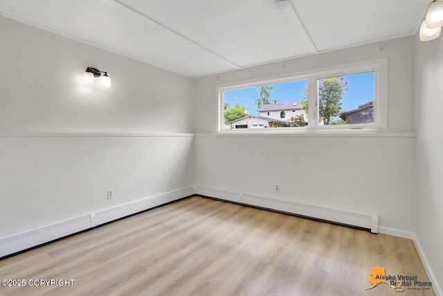 1915 Stanford Dr, Anchorage, AK 99508 - empty room with attic access, a baseboard heating unit, and wood finished floors