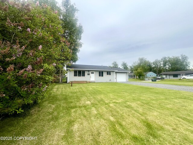 150 S Leibrock St, Soldotna, AK 99669 - view of front of home with driveway, an attached garage, and a front yard