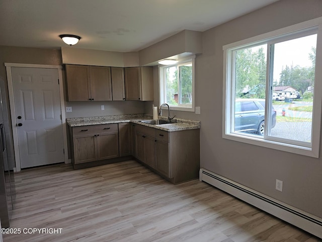 150 S Leibrock St, Soldotna, AK 99669 - kitchen with baseboard heating, light wood-style flooring, and light stone countertops