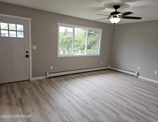 150 S Leibrock St, Soldotna, AK 99669 - foyer entrance featuring healthy amount of natural light, baseboard heating, ceiling fan, and light wood-style flooring