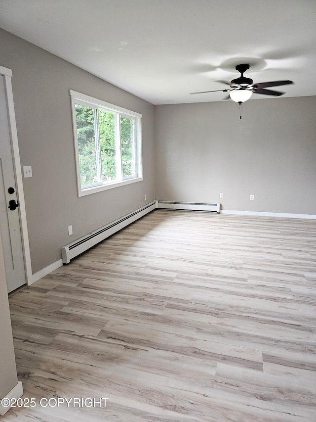 150 S Leibrock St, Soldotna, AK 99669 - spare room with a baseboard radiator, wood finished floors, and a ceiling fan