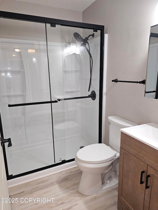 150 S Leibrock St, Soldotna, AK 99669 - bathroom with vanity, wood finished floors, a stall shower, and a textured wall