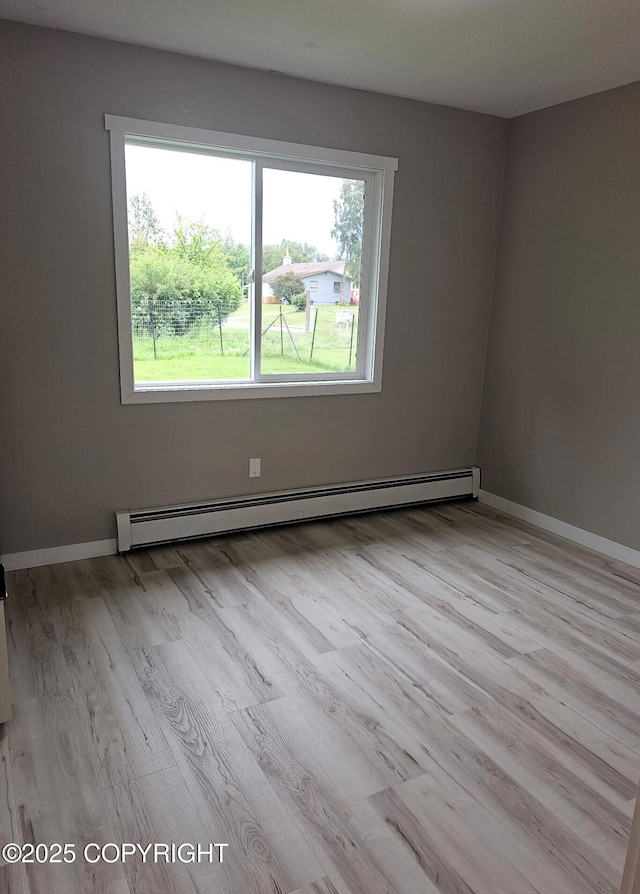 150 S Leibrock St, Soldotna, AK 99669 - spare room with a baseboard heating unit and wood finished floors