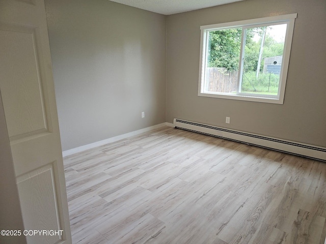 150 S Leibrock St, Soldotna, AK 99669 - empty room featuring baseboard heating and wood finished floors