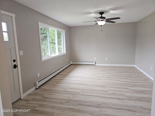 150 S Leibrock St, Soldotna, AK 99669 - spare room with a baseboard heating unit, a ceiling fan, and light wood finished floors