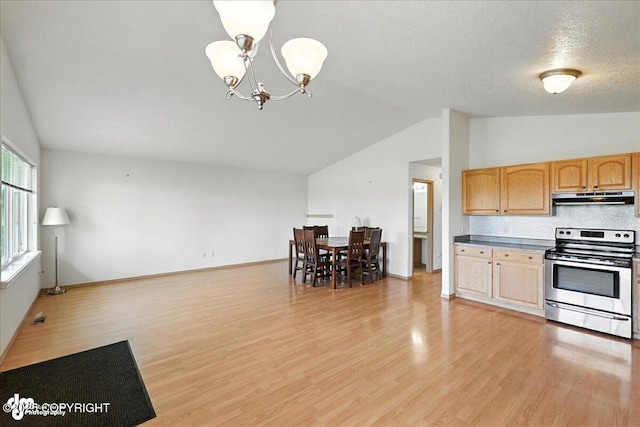 46640 Jo Ave, Kenai, AK 99611 - kitchen with stainless steel range with electric stovetop, under cabinet range hood, vaulted ceiling, a chandelier, and light wood finished floors