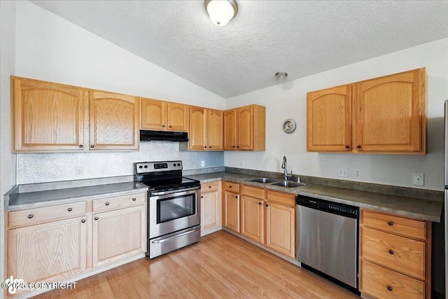 46640 Jo Ave, Kenai, AK 99611 - kitchen featuring stainless steel appliances, under cabinet range hood, vaulted ceiling, dark countertops, and a textured ceiling