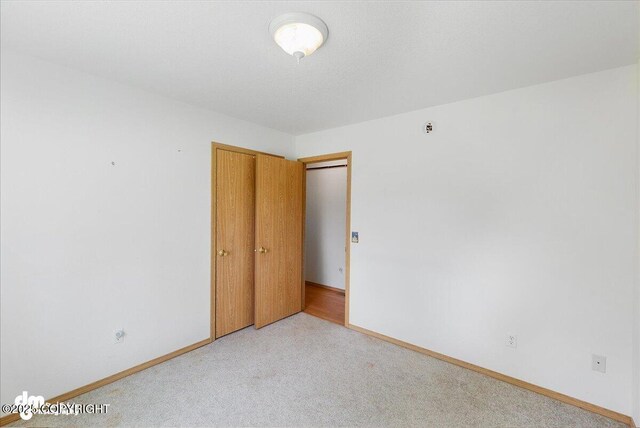 46640 Jo Ave, Kenai, AK 99611 - unfurnished room with light carpet and baseboards