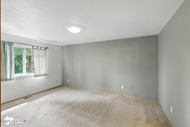 46640 Jo Ave, Kenai, AK 99611 - carpeted empty room featuring baseboards and a textured ceiling