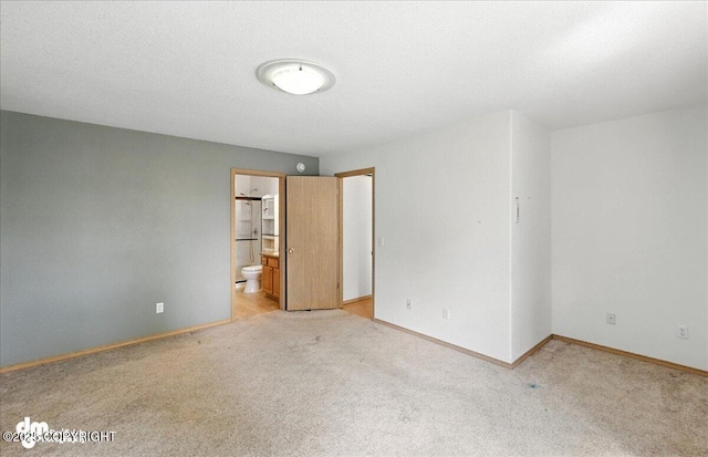 46640 Jo Ave, Kenai, AK 99611 - unfurnished bedroom featuring light carpet and connected bathroom