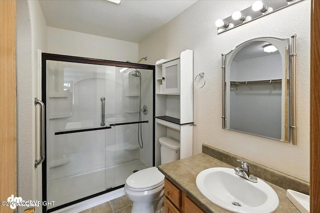 46640 Jo Ave, Kenai, AK 99611 - bathroom featuring a shower stall, vanity, and a textured wall