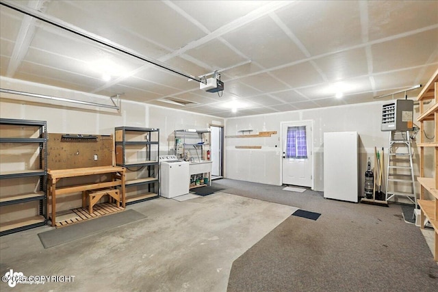 46640 Jo Ave, Kenai, AK 99611 - garage featuring washer / clothes dryer, a heating unit, a garage door opener, and freestanding refrigerator