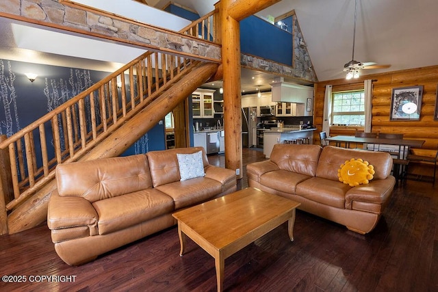 2415 Afognak Ave, Seward, AK 99664 - living room featuring high vaulted ceiling, hardwood / wood-style flooring, log walls, stairway, and ceiling fan