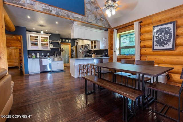 2415 Afognak Ave, Seward, AK 99664 - dining space featuring ceiling fan, dark wood finished floors, high vaulted ceiling, and log walls
