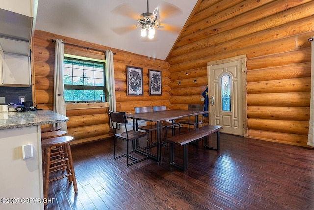 2415 Afognak Ave, Seward, AK 99664 - dining space featuring a ceiling fan, dark wood-style flooring, rustic walls, and high vaulted ceiling