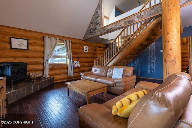 2415 Afognak Ave, Seward, AK 99664 - living area featuring rustic walls, stairs, high vaulted ceiling, a wood stove, and wood-type flooring