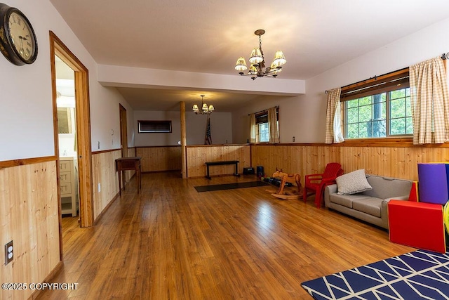 2415 Afognak Ave, Seward, AK 99664 - living area with a chandelier, a wainscoted wall, wood finished floors, and wood walls