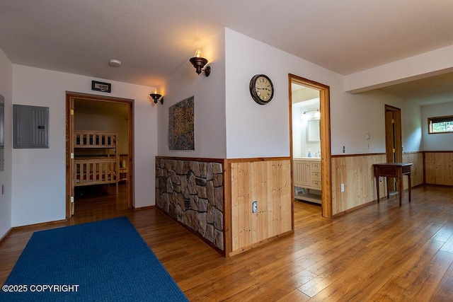 2415 Afognak Ave, Seward, AK 99664 - hallway featuring wainscoting, hardwood / wood-style floors, electric panel, and wooden walls