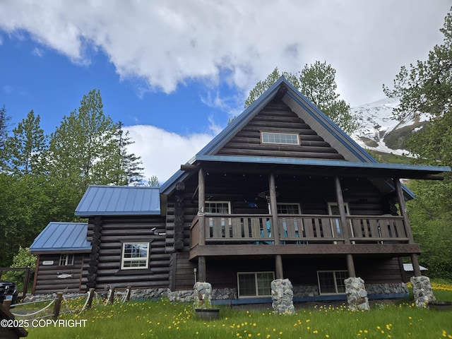 2415 Afognak Ave, Seward, AK 99664 - rear view of house featuring log exterior, a metal roof, a standing seam roof, and a mountain view