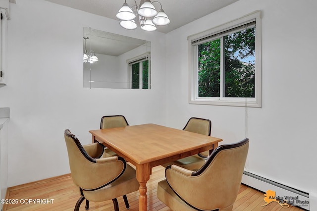 3958 Reka Dr Unit A-2, Anchorage, AK 99508 - dining area with baseboard heating, a chandelier, and light wood-type flooring