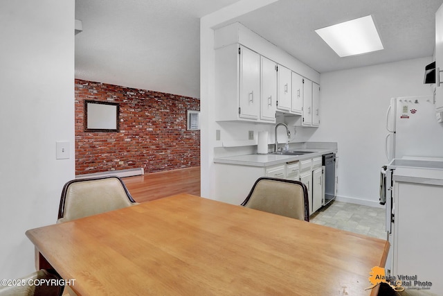 3958 Reka Dr Unit A-2, Anchorage, AK 99508 - kitchen featuring brick wall, freestanding refrigerator, white cabinets, light countertops, and dishwasher