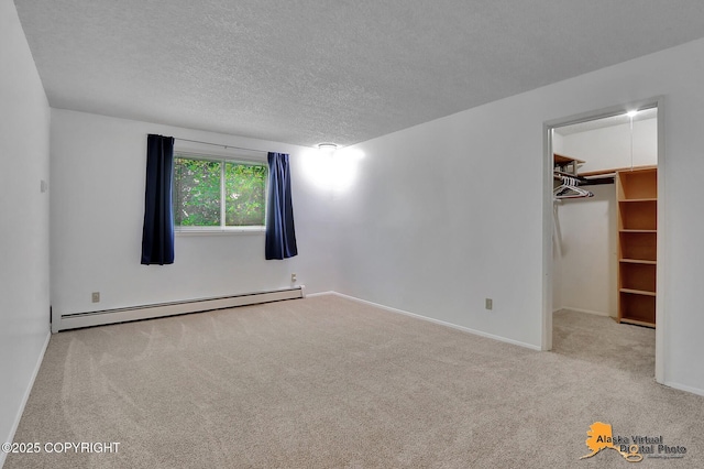 3958 Reka Dr Unit A-2, Anchorage, AK 99508 - unfurnished bedroom with a baseboard heating unit, carpet floors, a walk in closet, and a textured ceiling