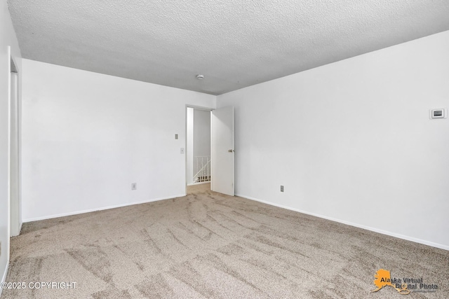 3958 Reka Dr Unit A-2, Anchorage, AK 99508 - carpeted empty room with a textured ceiling and baseboards