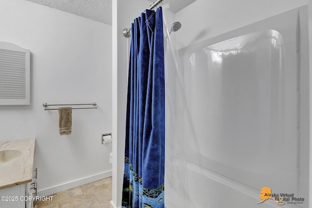 3958 Reka Dr Unit A-2, Anchorage, AK 99508 - full bath featuring vanity, a textured ceiling, and curtained shower