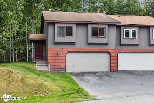 18644 Eaglewood Loop, Eagle River, AK 99577 - view of front of property featuring a garage, a shingled roof, asphalt driveway, and a front lawn
