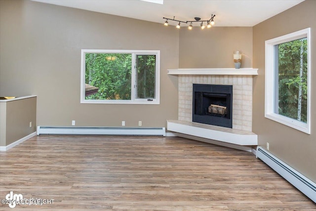 18644 Eaglewood Loop, Eagle River, AK 99577 - unfurnished living room with baseboard heating, wood finished floors, and a fireplace