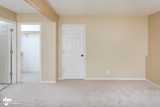 18644 Eaglewood Loop, Eagle River, AK 99577 - unfurnished bedroom with a walk in closet, carpet flooring, and a closet