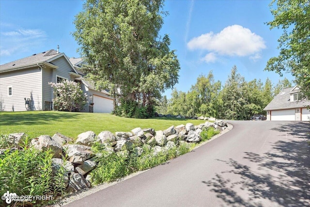 2436 N Hope Cir, Palmer, AK 99645 - view of green lawn featuring a garage