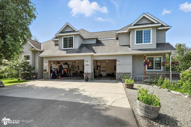2436 N Hope Cir, Palmer, AK 99645 - view of front of property featuring concrete driveway, roof with shingles, an attached garage, and covered porch