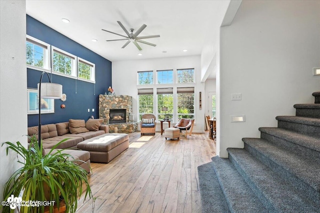 2436 N Hope Cir, Palmer, AK 99645 - living room featuring wood-type flooring, a ceiling fan, stairway, recessed lighting, and a stone fireplace