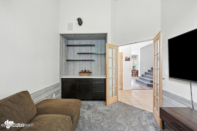 2436 N Hope Cir, Palmer, AK 99645 - living room with light tile patterned floors, stairway, light colored carpet, and a high ceiling