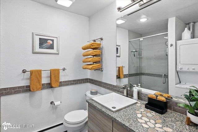 2634 Forest Park Dr # 114, Anchorage, AK 99517 - full bathroom with stacked washer and clothes dryer, vanity, a shower stall, and a baseboard heating unit