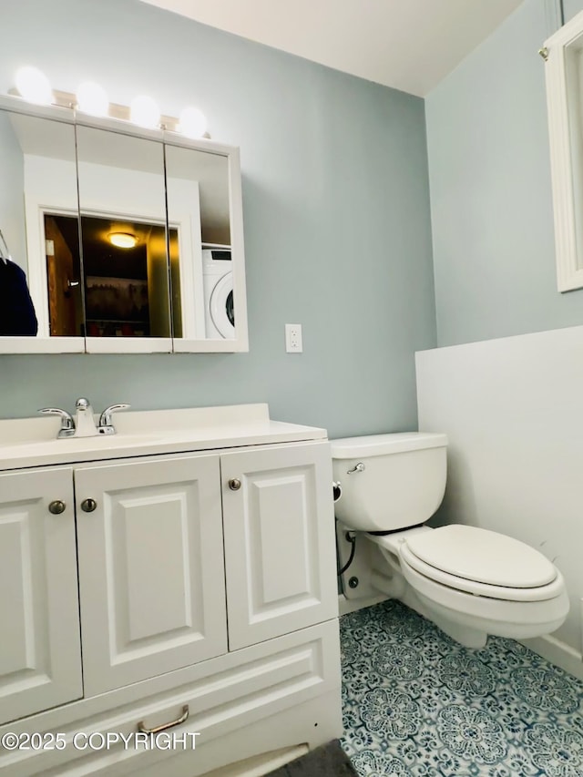 2703 David St, Juneau, AK 99801 - bathroom with washer / dryer, vanity, and tile patterned flooring