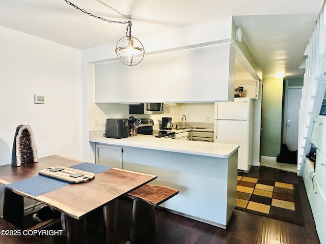 2703 David St, Juneau, AK 99801 - kitchen featuring freestanding refrigerator, stainless steel microwave, electric range oven, a peninsula, and light countertops